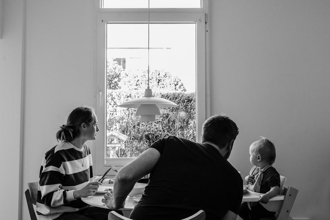 Familie sitzt am Tisch und isst zu Mittag